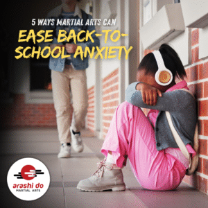 Middle-school aged child sitting on the ground in a school hallway. Her head is in her hand as she struggles with anxiety.