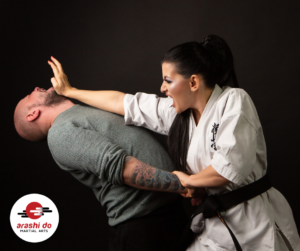 Image of a woman black belt striking a male attacker in self-defense